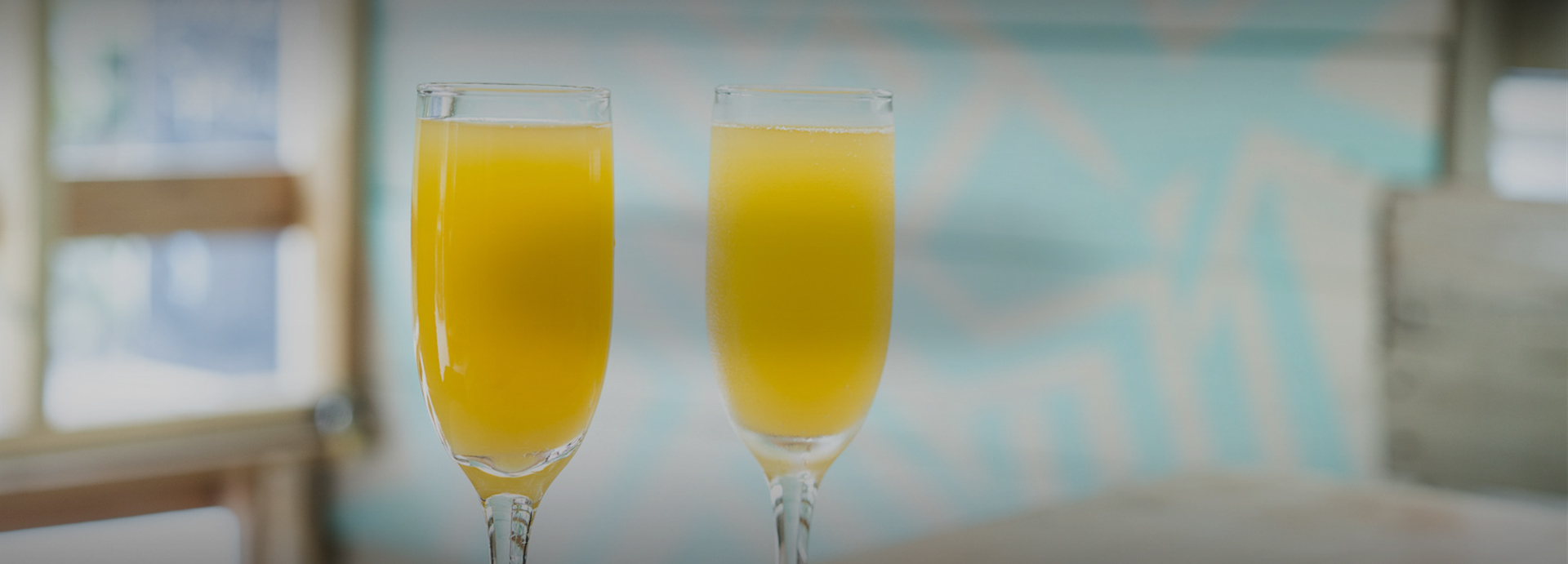 two mimosas in champagne flutes