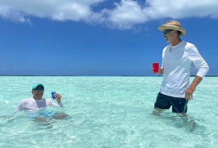 two men enjoying the water and having some drinks