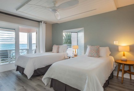 two-bed room with balcony and ocean view