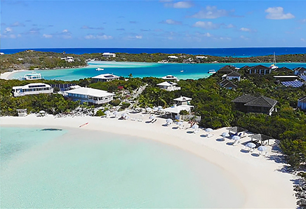 shore of the beach with crystal clear water, and beach chairs and umbrellas in front