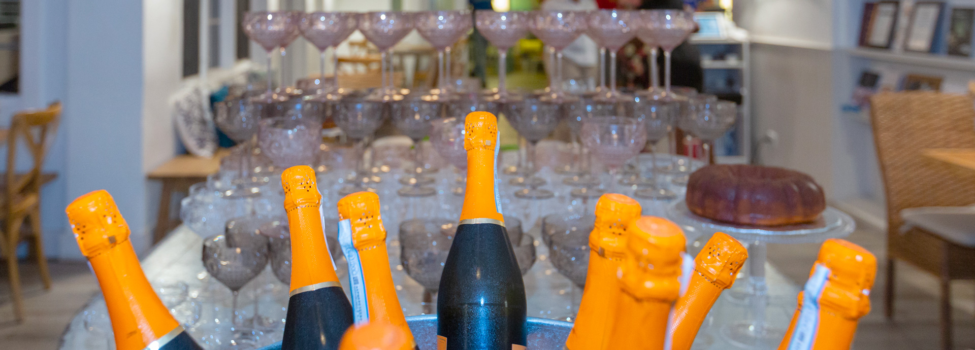 close up of some champagne bottles and glasses in the background