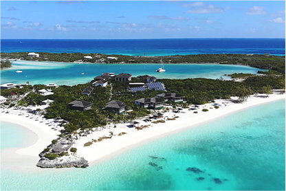 view of the shore beach in front of the resort in a sunny day