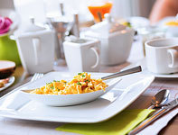 Scrambled eggs next to coffee