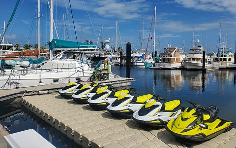 jet skis on dock with boats in the background