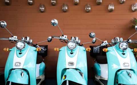 three parked blue motorbikes 