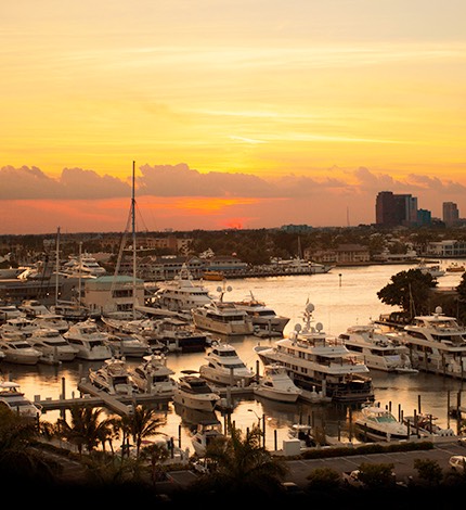 boats docked at the marina as the sun sets