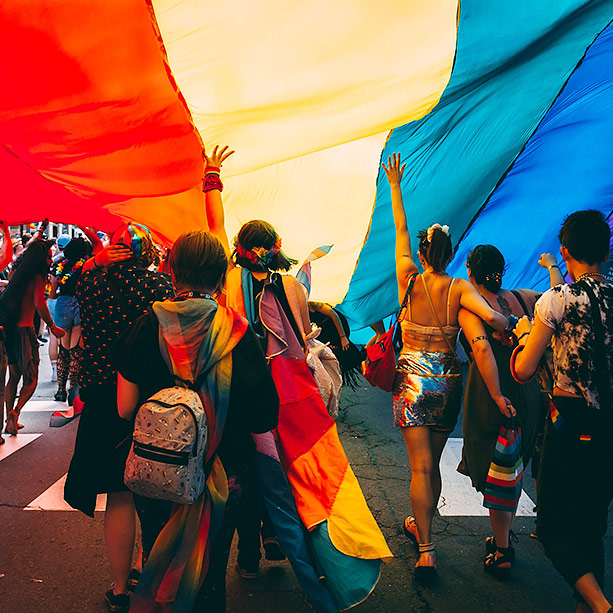 Crowd of people under colorful tarp
