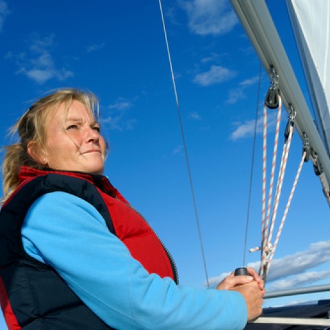 woman steerling sailboat