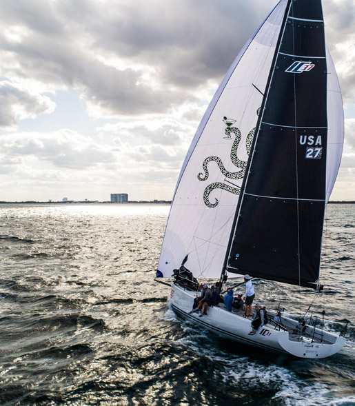 a sailboat in the ocean with people on it