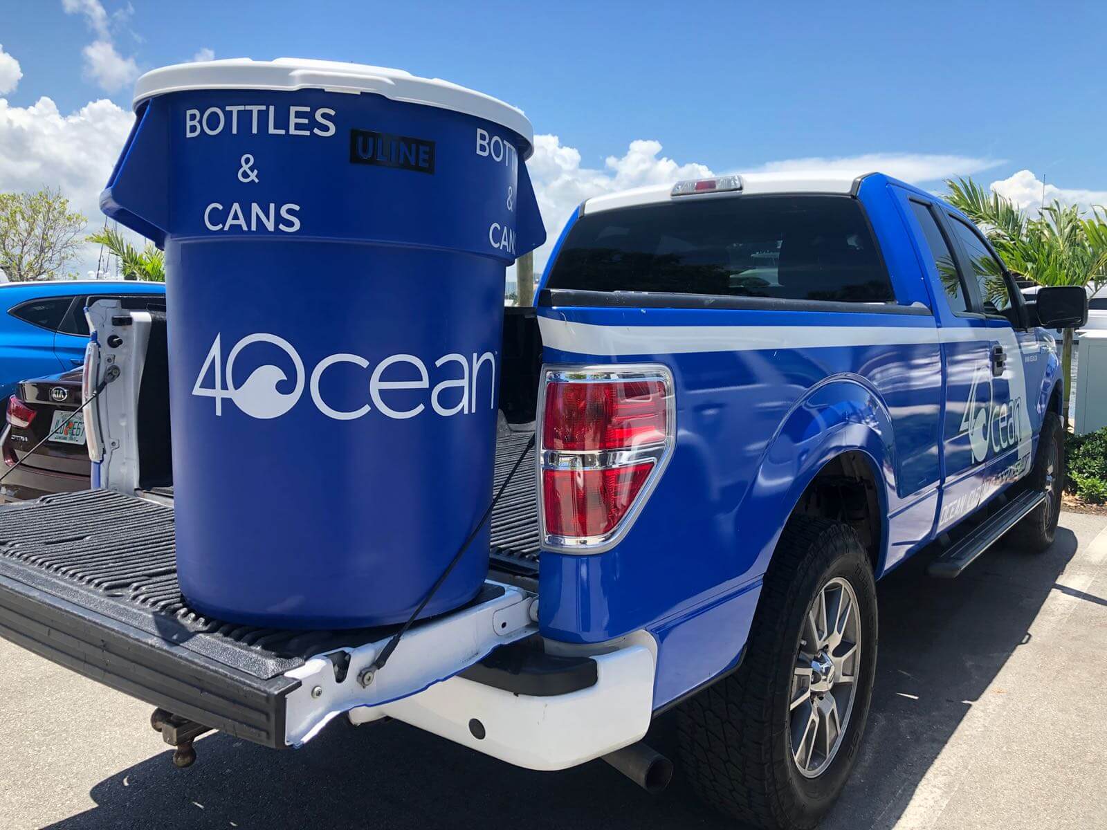 pick up truck with a 4Ocean branded trash can