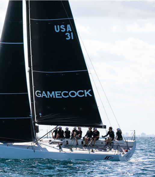 a sailboat in the ocean with people on it