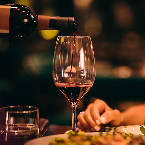 red wine being poured into a glass