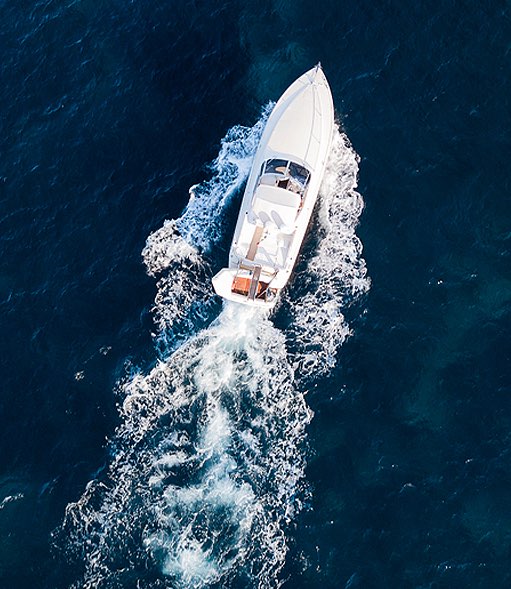 aerial view of a boat driving off in the ocean