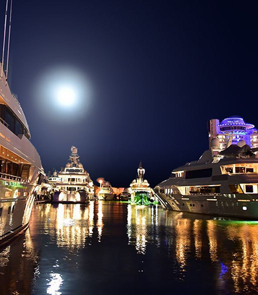marina at night time with boats and yachts