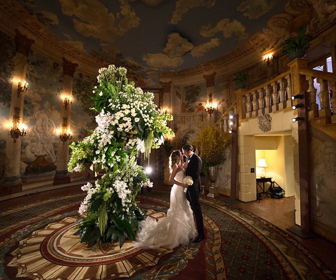 bride and groom posing in rotunda