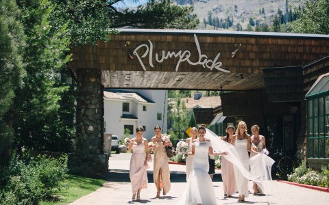 A happy bride and her bridesmaid walking on the property