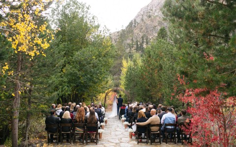 A wedding ceremony in the middle of trees in autumn season 