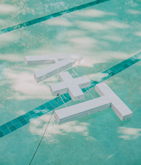 Top view of an A + T letters on a pool 