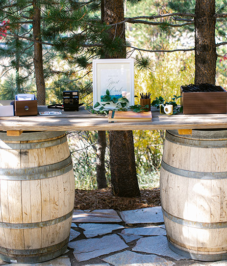 Closeup of two barrels holding a table with some cameras outdoors
