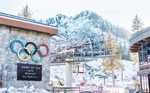 the winter olympics sign next to the ski lift