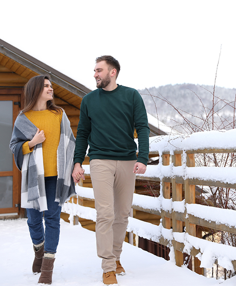 View of a couple walking on a snow bridge