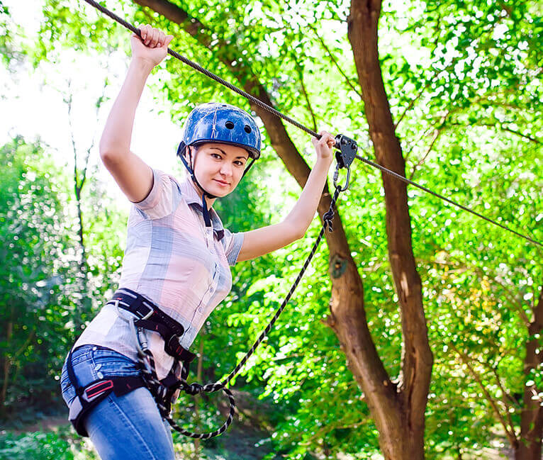 A woman climbing high wire