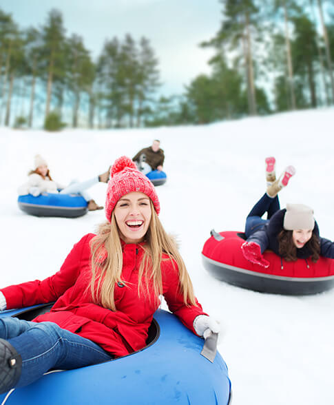 View of some happy girls doing snow tubing