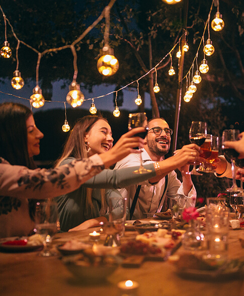 View of a group of friends toasting and celebrating outdoors 