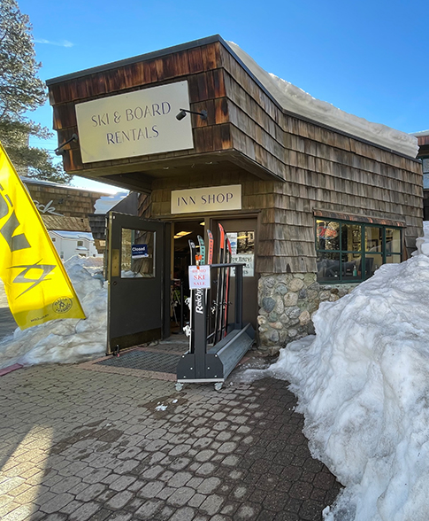 Front view of the Inn Shop Rentals store surrounded by snow