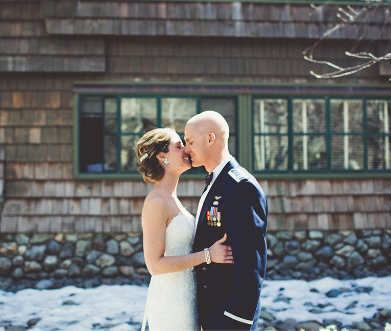 bride and groom outside of lodge
