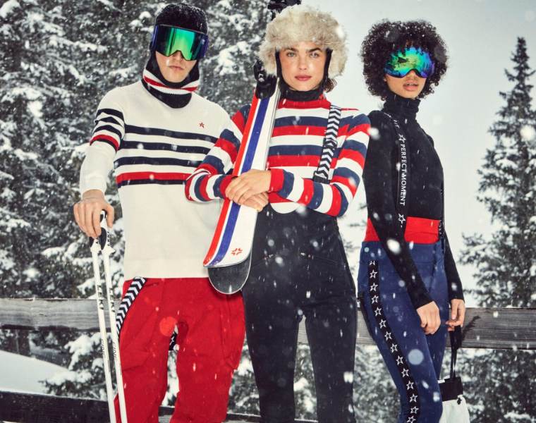Models dressed in ski gear posing for a picture