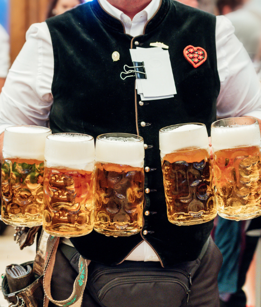 man holding. beers during oktoberfest