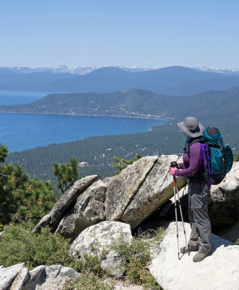 Man at the top of the mountain looking over Lake Tahoe