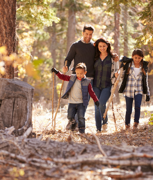 Family walking in a forrest during autumn