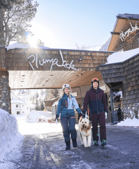 couple with dog walking outside of PlumpJack Inn 