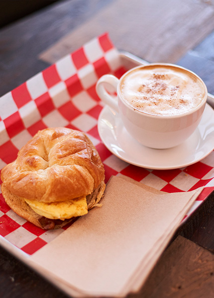 breakfast croissant sandwich with cappuccino 