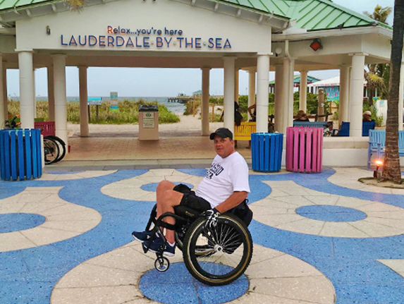 man in a wheelchair in front of the hotels entrance