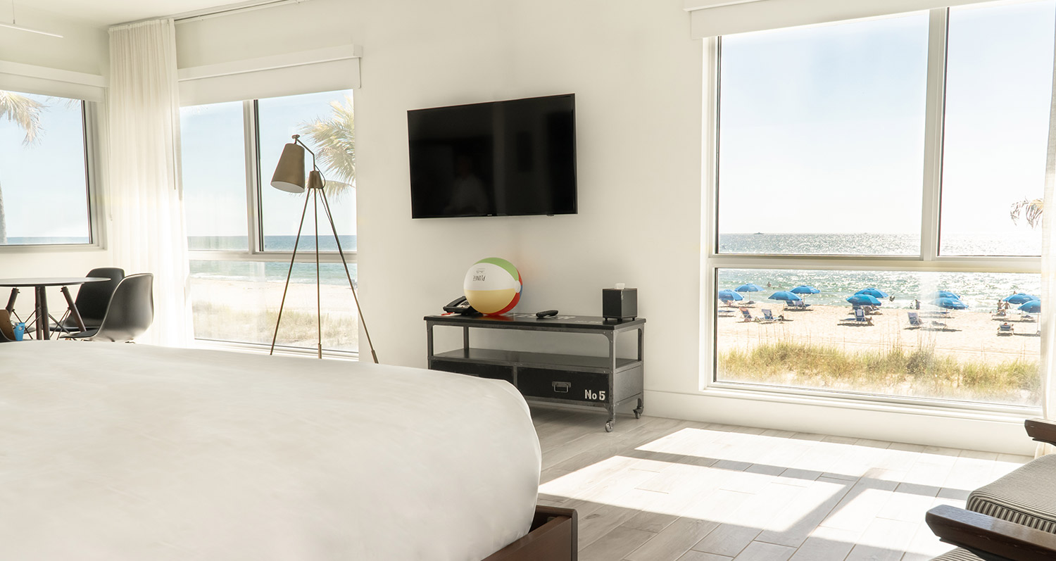 Plunge ocean view room with white linens and clean design elements