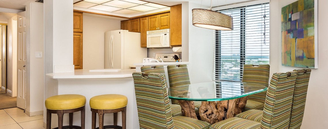 suite with kitchen with bar stools and dining room 