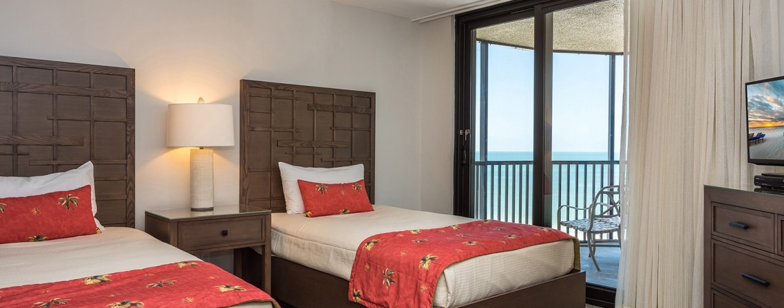 beachfront penthouse suite bedroom with two twin beds