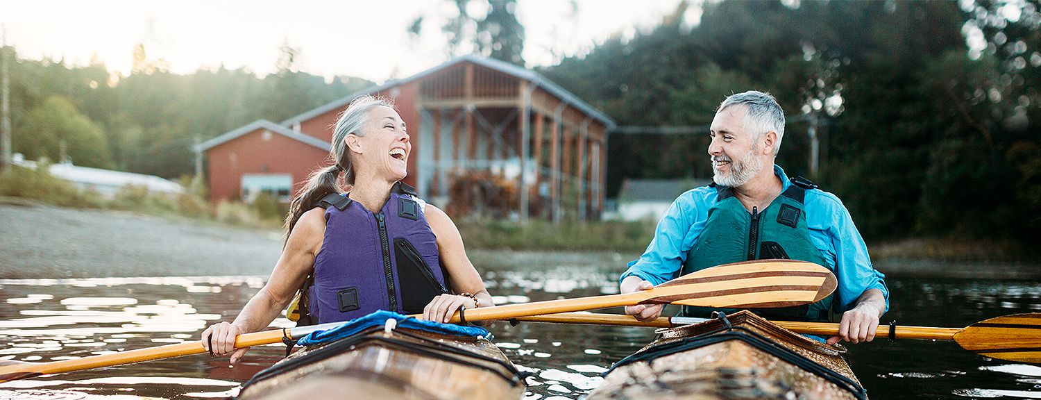 Older couple kayaking next to each other