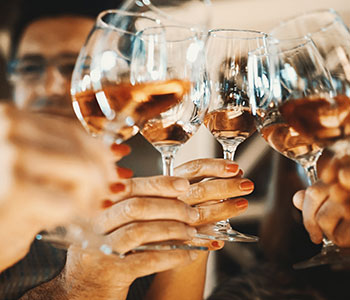 group of people toasting wine glasses