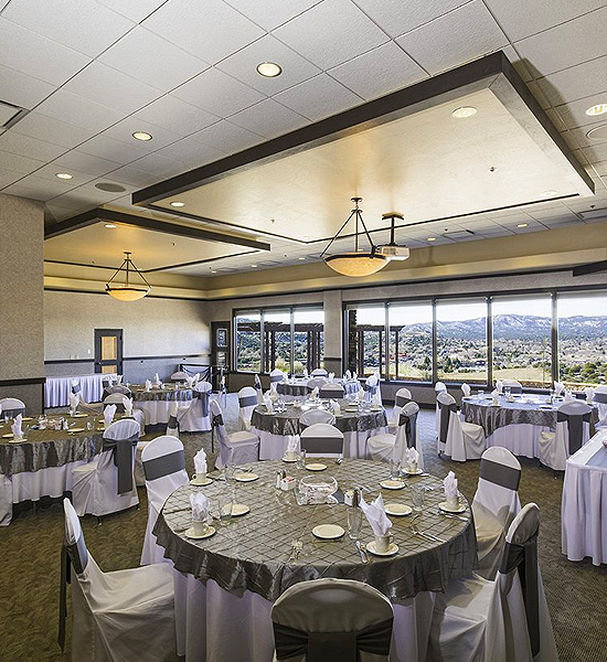 large meeting area with multiple round tables and chairs