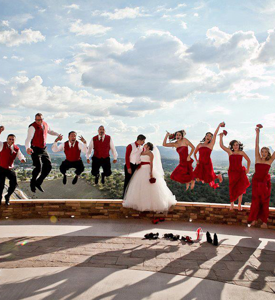 bride and groom jumping with their bridal party