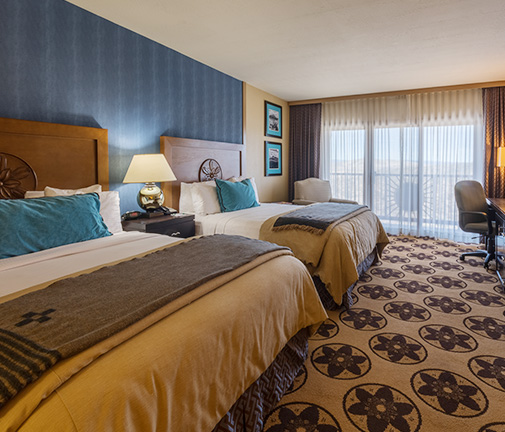 double beds in a hotel room with carpet floors