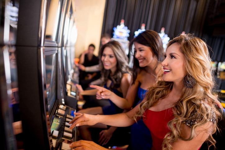 women playing at the casino machines