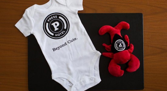 Press hotel baby onesie with lobster stuffed animal