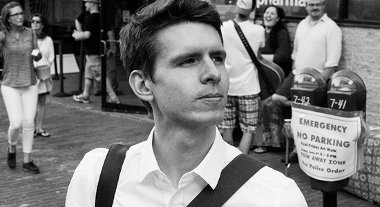 Black & white portrait of young man looking off in the distance