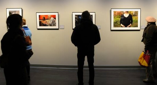 People in gallery looking at artworks on wall