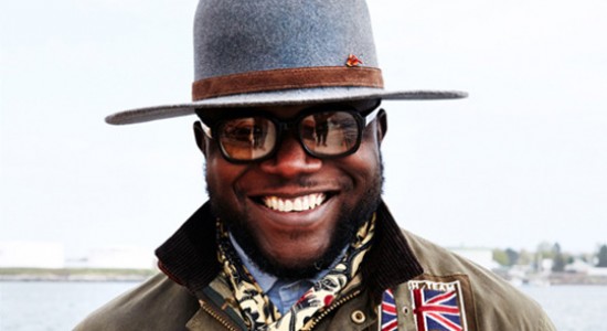 Portrait of African American man smiling, wearing jacket & hat